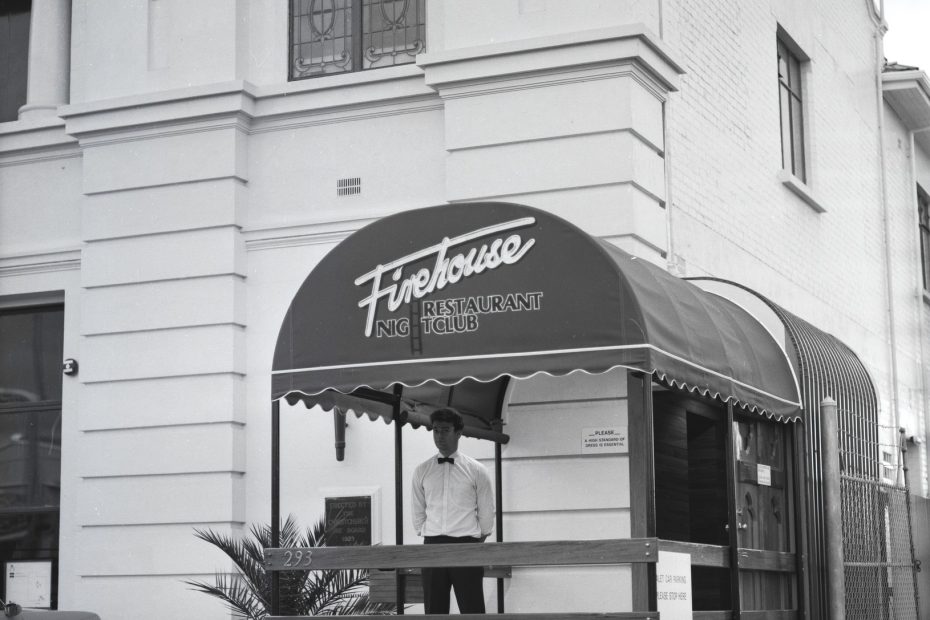 Firehouse Restaurant Nightclub entrance at 293 Colombo Street, Sydenham, Christchurch, showing the distinctive arched awning and a doorman in bow tie